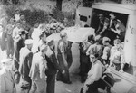 Jewish policemen hoist a coffin onto a truck during the funeral for another Jewish policeman in the Feldafing DP camp.