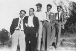 Five Jewish young men pose outdoors standing in a line.