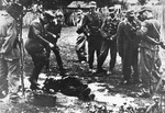 A soldier with a unit of German mountain troops kicks a man to death during the "cleansing" of the Macva region in September 1941.