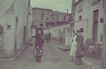 Two men and a female nurse converse outside the furniture factory in the Lodz ghetto.