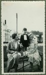 A young Lithuanian Jewish boy dressed in formal clothes poses on a park bench between his mother and nanny, near his home on Vienybes Square in Kaunas.