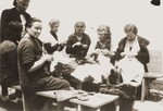 Female internees sew in a workshop organized by the Secours Suisse aux Enfants.