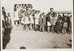 Children and asi workers pose outside the barracks of the Secours Suisse aux enfants in Rivesaltes.