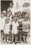 Friedel Reiter poses with a group of children in the Rivesaltes internment camp.