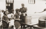 Children in the Rivesaltes transit camp receive food from Secours Suisse.