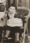 Portrait of a young Jewish girl seated in a wicker chair at the Fuerth displaced persons camp.