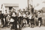 Children display packages from their Swiss "godparents" in the Rivesaltes internment camp.