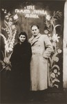 Two young Jewish DPs pose beneath a sign in Russian that reads "Memories from the town of Lvov."

Pictured are Eugenia Hochberg and Izio Pestes, a fellow Polish Jew from Brody, who is a soldier in the Soviet Red Army.