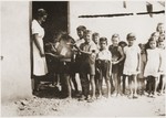 Children line up for food rations from Secours Suisse aux enfants.