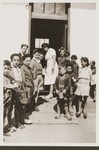 Children await the distribution of special rations from the Secours Suisse aux enfants.