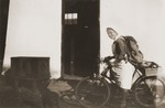 Secours Suisse relief worker Friedel Reiter, rides a bicycle in the Rivesaltes internment camp.