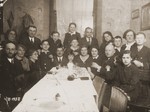 Members of the extended Hochberg family gather around a table during the celebration of the bar mitzvah of Sigmund Hochberg.