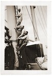 Four Jewish refugee friends pose while climbing a mast ladder on the deck of the SS St.