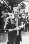 Close-up of a man holding a sewing kit in the Zeilsheim displaced persons' camp.
