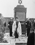 A cantor wearing a prayer shawl recites a prayer in front of a new monument erected at the Zeilsheim displaced persons camp in memory of the Jews killed by the Nazi regime.