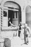 A woman receives food through the window of a building in the Zeilsheim displaced persons' camp.