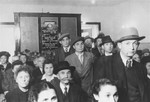 Jewish displaced persons gather for prayers before a newly installed memorial plaque in the chapel at the Zeilsheim DP camp.