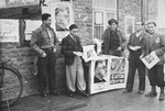Election committee members distribute campaign posters in the Zeilsheim displaced persons' camp.
