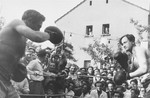 Two boxers spar in the ring during a sports event at the Zeilsheim displaced persons' camp.