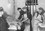 Butchers carve meat in the Zeilsheim displaced persons' camp.
