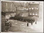 German soldiers rounding up Jews on Francuska Street in the Dombrowa ghetto.