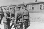 Officials at the Monowitz-Buna building site greet Reichsfuehrer SS Heinrich Himmler and his inspection team.
