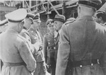 Officials at the Monowitz-Buna building site greet Reichsfuehrer SS Heinrich Himmler and his inspection team.