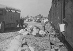 Prisoners in the Aufräumungskommando (order commandos) sort through a mound of personal belongings confiscated from the arriving transport of Jews from Subcarpathian Rus.