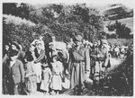 Yugoslav women and children are escorted by Ustasa militiamen to the Jasenovac concentration camp.