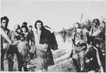 Soldiers lead a group of Serbian villagers from the Kozara region who are being deported to Croatian concentration camps.