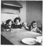 The Cassuto children sit around a kitchen table.

Pictured are Susanna, David, their cousin Umberto DiGiaccino, and Daniel.