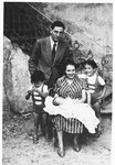 Rabbi and Mrs. Cassuto pose for a family portrait with their three oldest children.