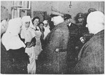 Croatian leader Ante Pavelic and Field Marshal Slavko Kvaternik talk to a group of nuns at an unidentified camp or institution.