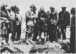 Members of the State Commission for the Investigation of Crimes Committed by the Occupiers and their Collaborators interview a group of men and women at the site ofthe Jasenovac III concentration camp.