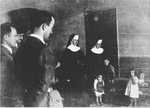 Croatian officials and Ustasa militia view a group of children in the care of nuns at the Jastrebarsko concentration camp.