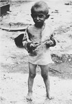 Portrait of an emaciated, partially clothed child in the Jasenovac concentration camp.