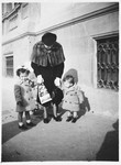 Anna Cassuto stands on a sidewalk in Florence with her children Susanna and David.