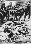Ustasa personnel at the Jasenovac concentration camp view a pile of confiscated property looted from prisoners interned in the camp.