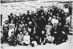 Group portrait of children who are being separated from their mothers by Ustasa guards, at the entrance to the Stara Gradiska concentration camp.