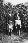 Two sisters pose with their respective sons in their parent's home in Borislav.