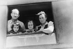 The Slepian family looks out a window of their train while on route to Bremerhaven, where they will board a ship to America.