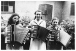 Three teenage Jewish girls play the accordian in the Gabersee displaced persons camp.