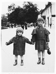Two Jewish sisters pose on a street in the resort town of Krynica, Poland.