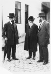 Three religious Jews converse on a street corner in Mukachevo.