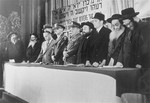American military officers stand at the dais with a group of orthodox rabbis at a DP conference in Frankfurt.
