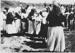 Grief stricken family members of prisoners killed at the Sisak concentration camp, gather along the banks of the Sava River where many bodies of camp victims were found.