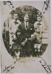 Portrait of a Jewish family sitting outside.

Pictured in the front row are Allegra Franko, Dario Nehama (seated), and Isaac Nehama (son of Solomon Nehama).