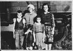 Members of a Serbian family pose in front of a railcar in the Pecana camp in Sisak.