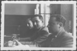 Close-up of three American prosecutors at the IMT Nuremberg commission hearings investigating indicted Nazi organizations.