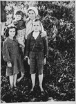 A Serbian mother poses with her three children at the Pecana camp in the Sisak concentration camp for children.